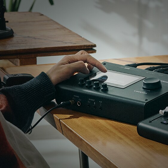 A URX console in situ on a desk in a well lit studio or practise space.