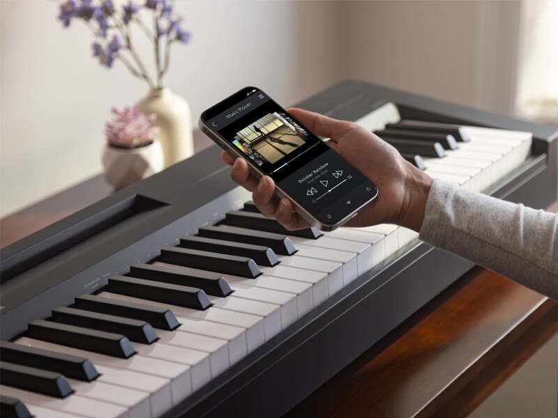 A person operating a smart phone to play music