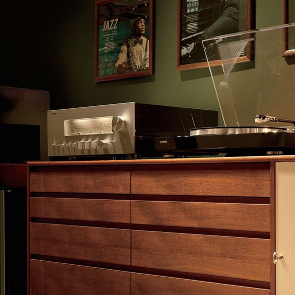 A NS-600A network reciever ontop of a vintage wooden cabinet