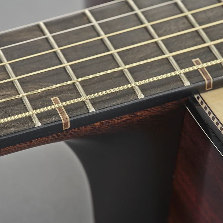 Close-up of a wooden fingerboard inlay inspired by traditional Japanese Kumiki woodworking.