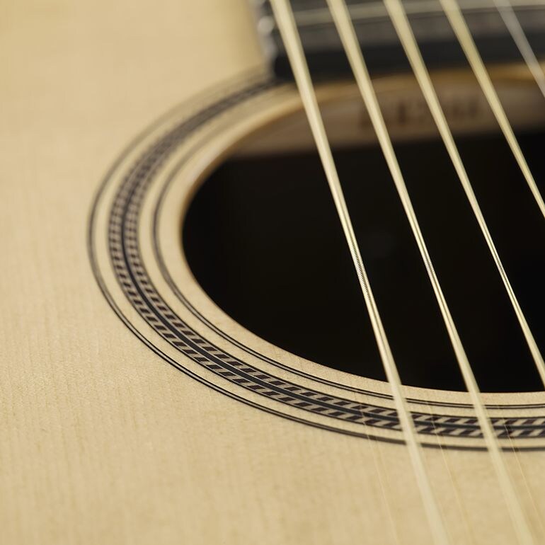 Close-up of a rope-shaped soundhole inlay, a motif deeply rooted in Japanese culture.