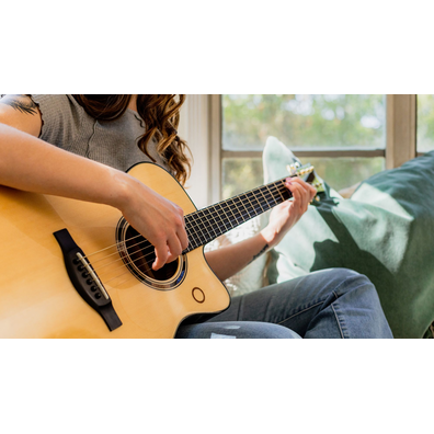 Close-up of a person playing the TAS3 C acoustic guitar.