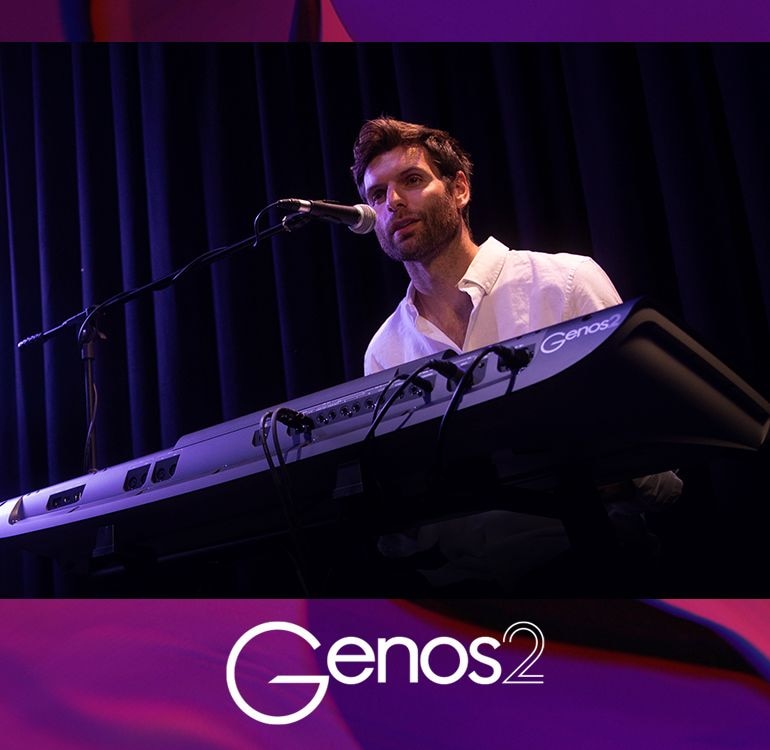 Genos2 logo and a photo of a man  singing into microphone while playing Genos2