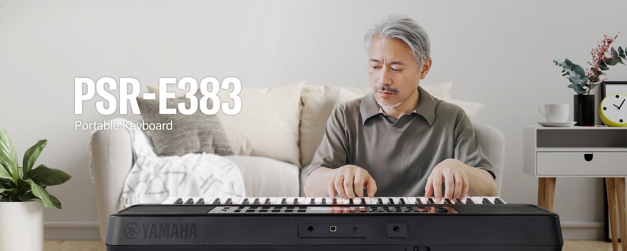 The man is playing the PSR-E383 enthusiastically.