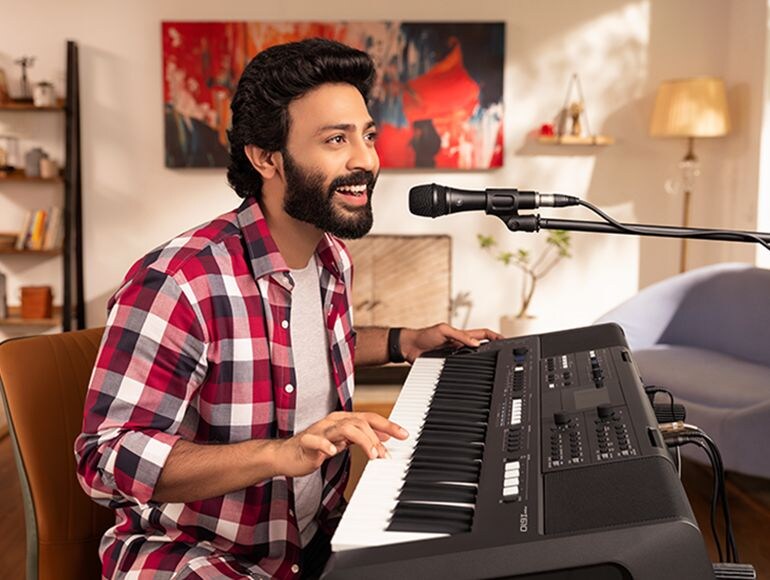 A hobbyist plays and sings with a microphone connected to the PSR-I610