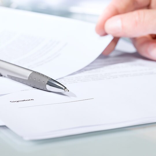 Image of warranty information, documents, and pens